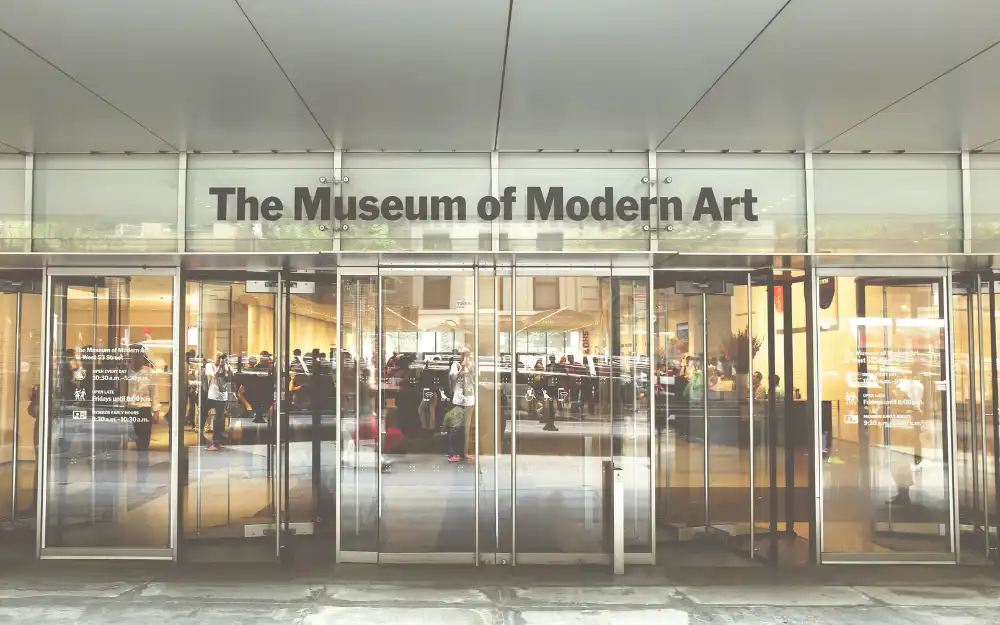 Things to Do in NYC 14 The glass entrance of the Museum of Modern Art on West 53rd Street in Manhattan