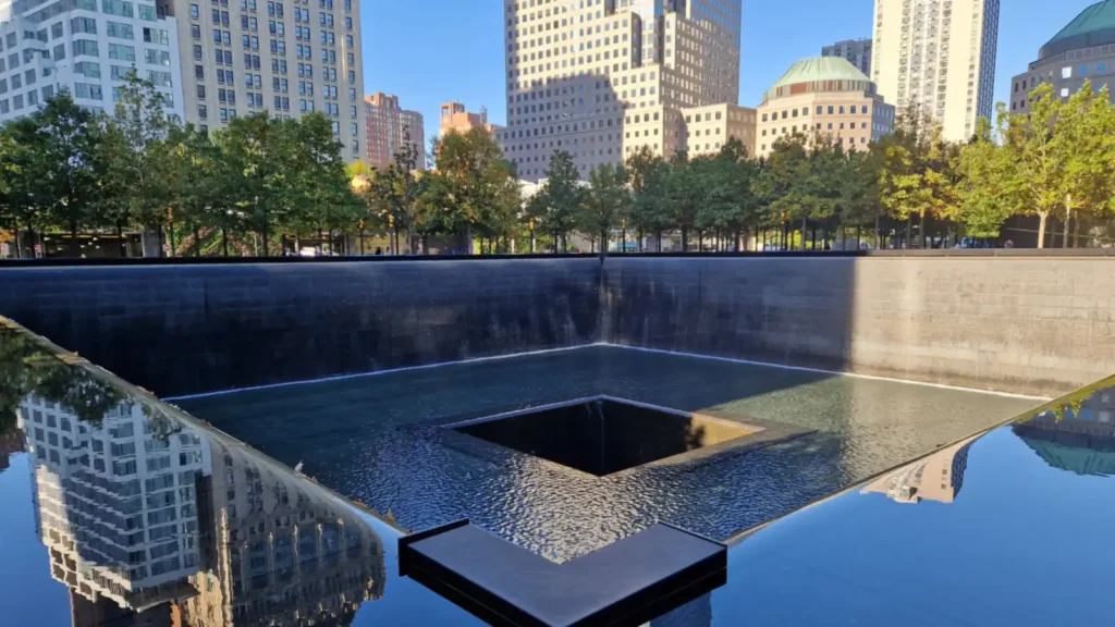 9/11 Memorial and Museum Tickets: Prices, Free Days, Hours 1 South Pool of the 9/11 Memorial in Lower Manhattan with the surrounding skyline reflected in the water