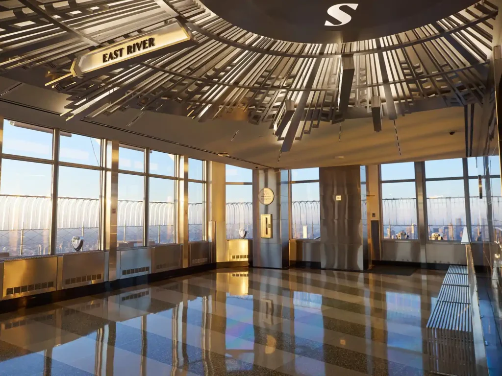 Empire State Building Tickets: Real Prices, the $5 Fee, and Where to Buy 3 The enclosed indoor section of the 86th Floor observatory at the Empire State Building, with its Art Deco ceiling and coin-operated viewers
