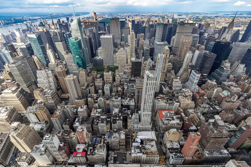 Empire State Building Tickets: Real Prices, the $5 Fee, and Where to Buy 1 View north over Midtown Manhattan from the Empire State Building observation deck, with the Chrysler Building and MetLife Building visible