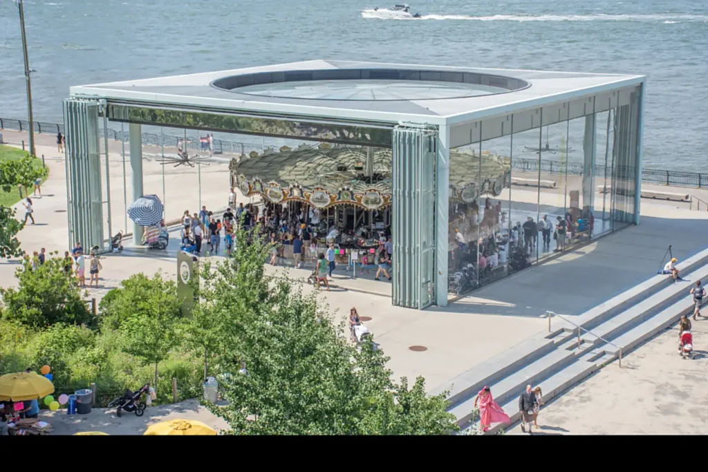 Brooklyn Bridge Park: Every Pier, What's Free, and When Things Are Actually Open 3 Jane's Carousel turning inside its glass pavilion beside the East River in DUMBO