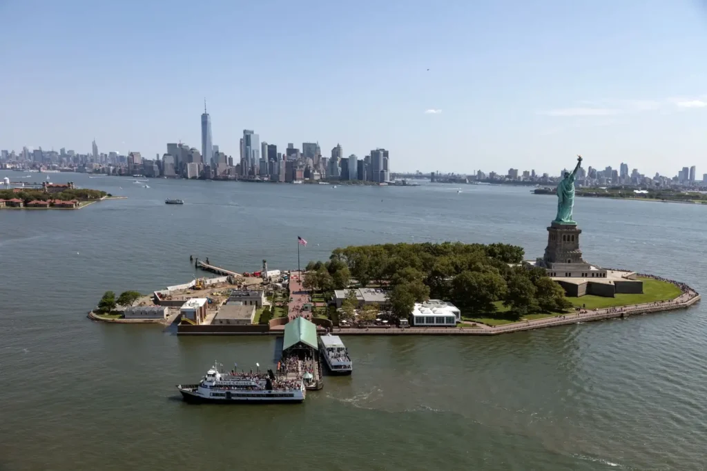 Statue of Liberty and Ellis Island: Tickets, Ferries, and What the Guides Miss 2 Liberty Island and Ellis Island in New York Harbor with Lower Manhattan behind, and ferries at the Liberty Island dock
