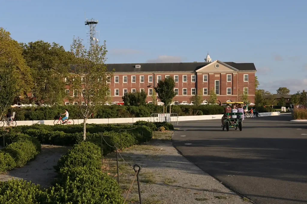 Governors Island: Free Ferries, Fort Hours, and the Rules Nobody Prints 2 Liggett Hall on Governors Island, the long brick barracks building, with visitors cycling past on Liggett Terrace